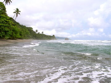 Small wooden fishing boat left anchored near the beach in Ponta do